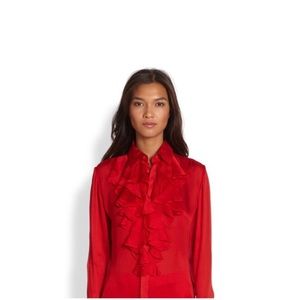 A red designer blouse made 100% from silk/sole.